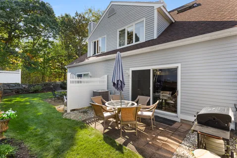 a view of a house with backyard sitting area and garden