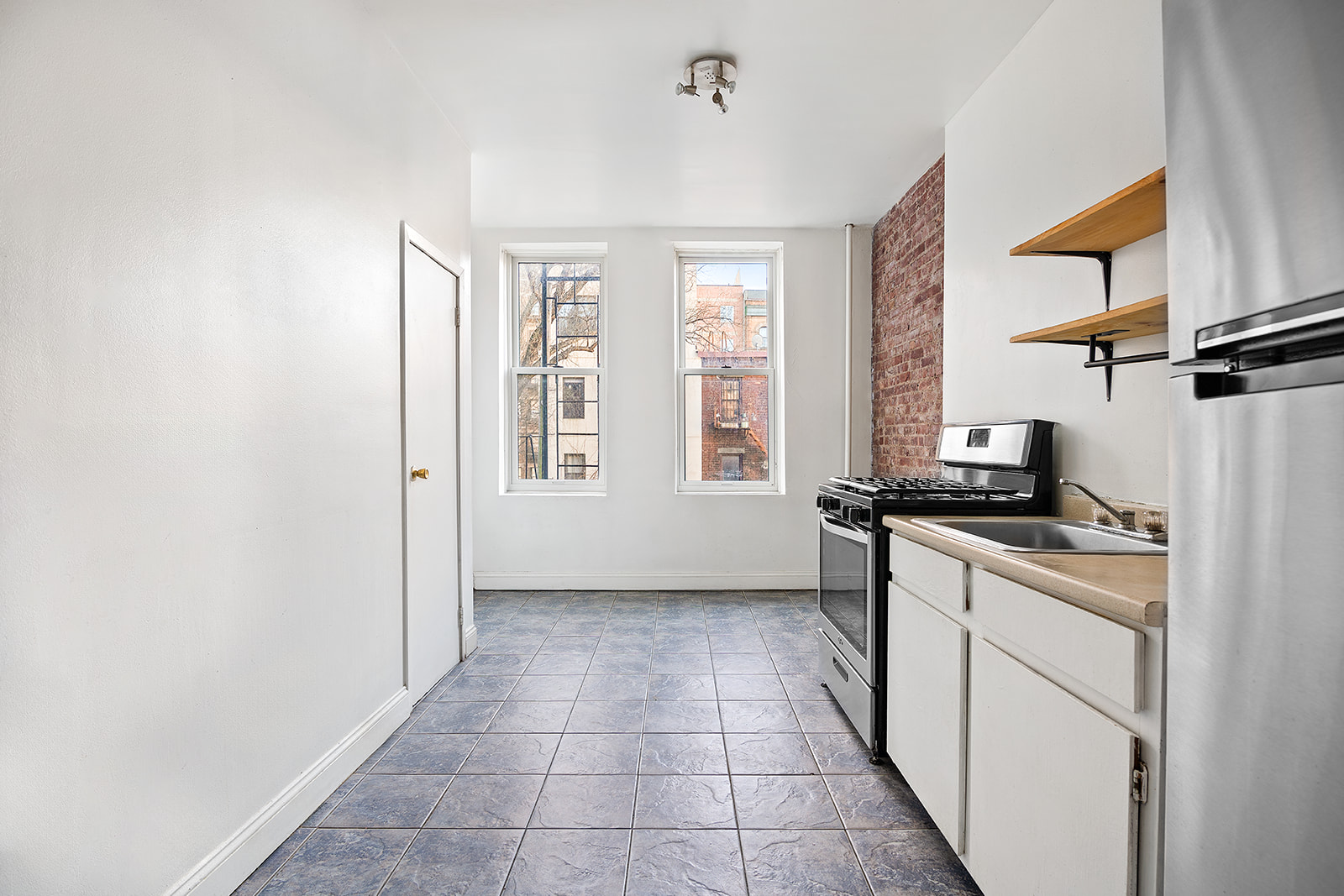 418 South 4th Street, Unit 2R Brooklyn, NY 11211 - Photo 4 of 6 a kitchen with stainless steel appliances granite countertop a refrigerator and a stove