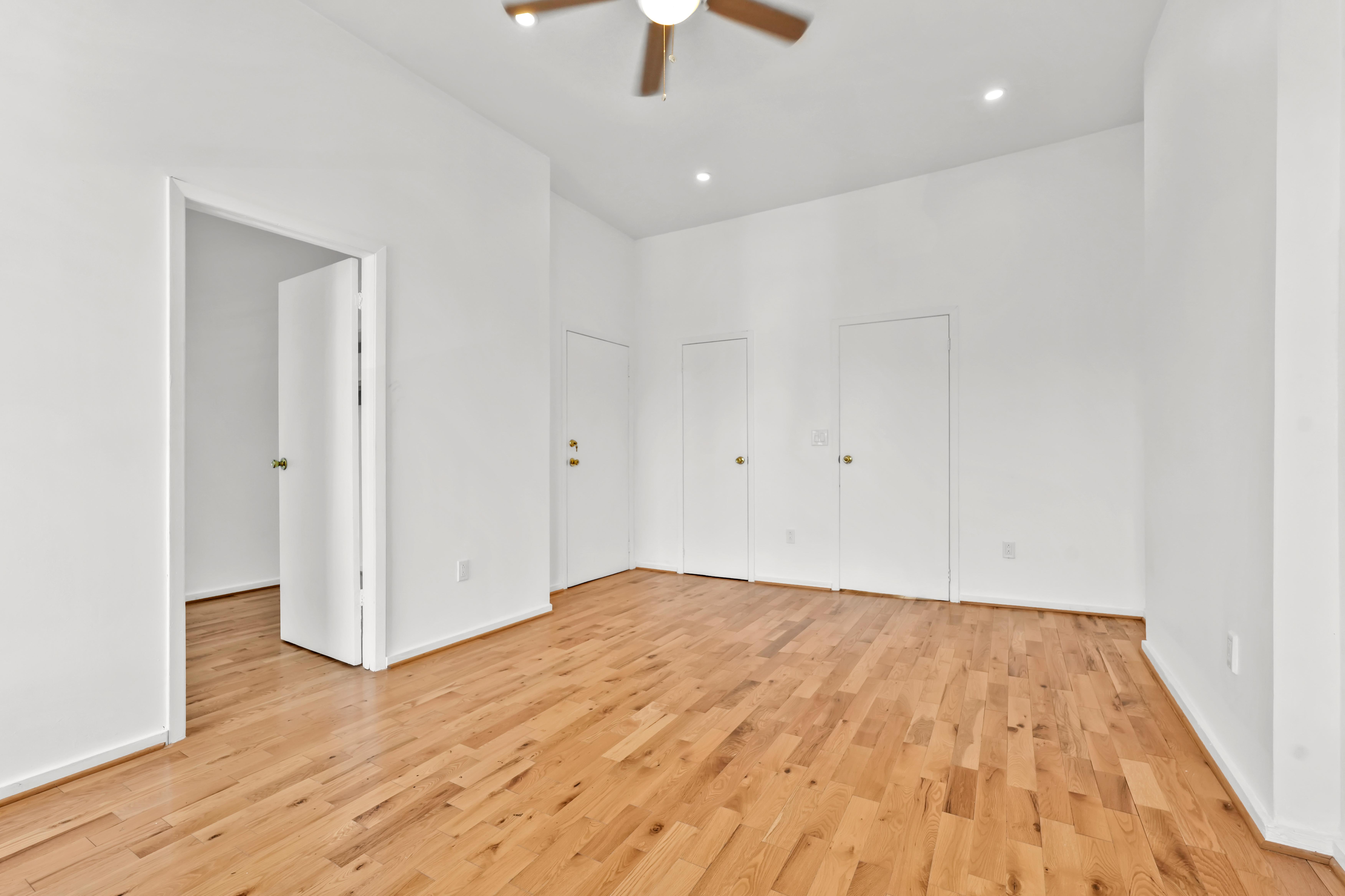 238 Vernon Avenue, Unit 2 Brooklyn, NY 11206 - Photo 6 of 21 a view of empty room with wooden floor and fan