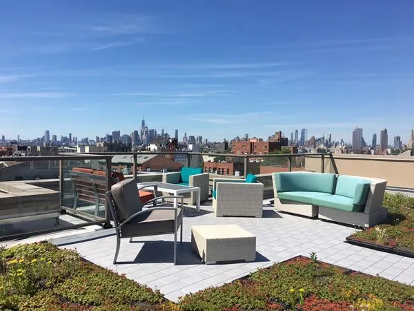 a view of a terrace with couches and city view
