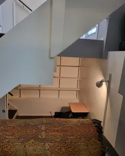 a room with pool table and wooden floor