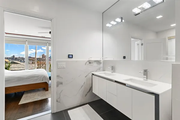 a bathroom with a sink double vanity and a mirror