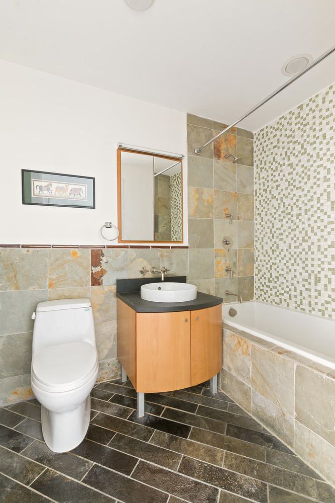 20 Broadway, Unit 501 Brooklyn, NY 11249 - Photo 4 of 8 a bathroom with a sink a toilet and bathtub