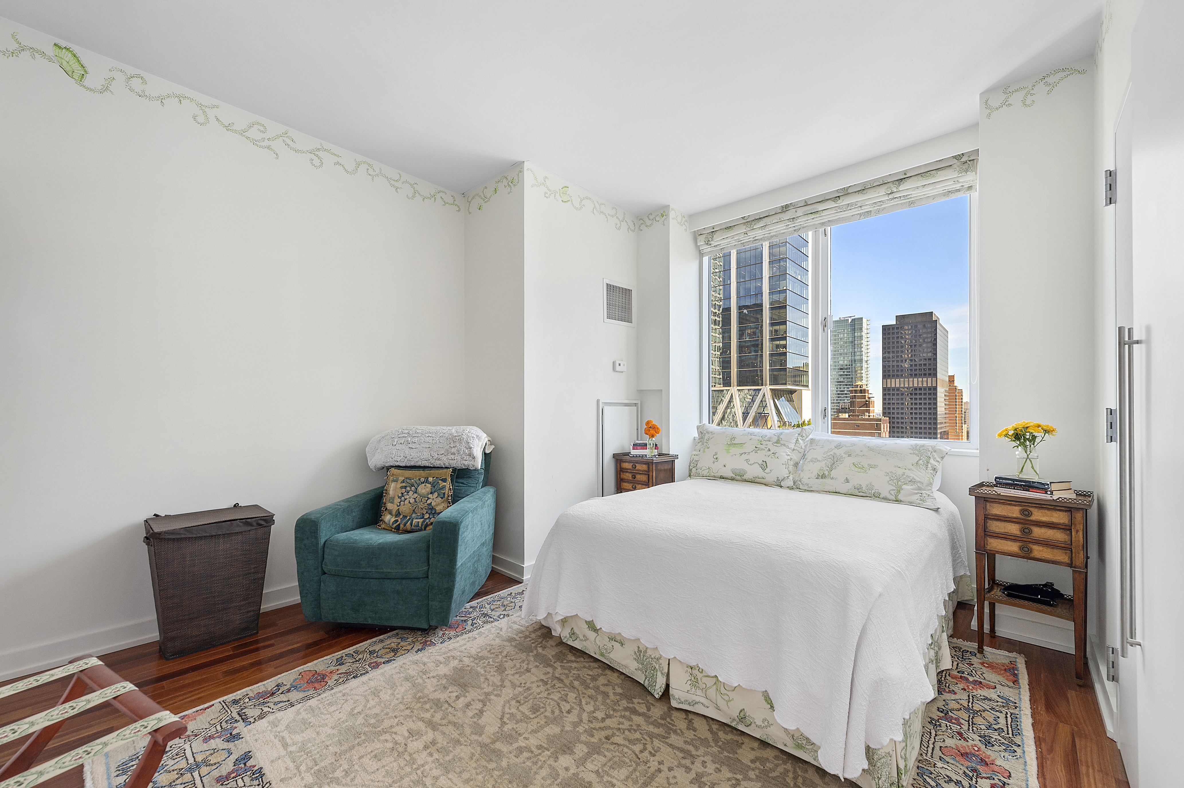 60 East 55th Street, Unit 40B Manhattan, NY 10022 - Photo 5 of 12 a bedroom with a bed and a chair