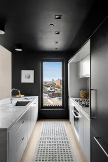 a kitchen with stainless steel appliances a stove a sink and a microwave