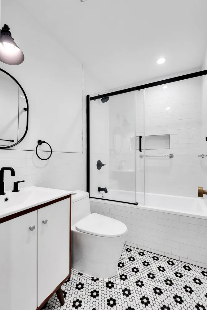 a bathroom with a sink a toilet and a shower