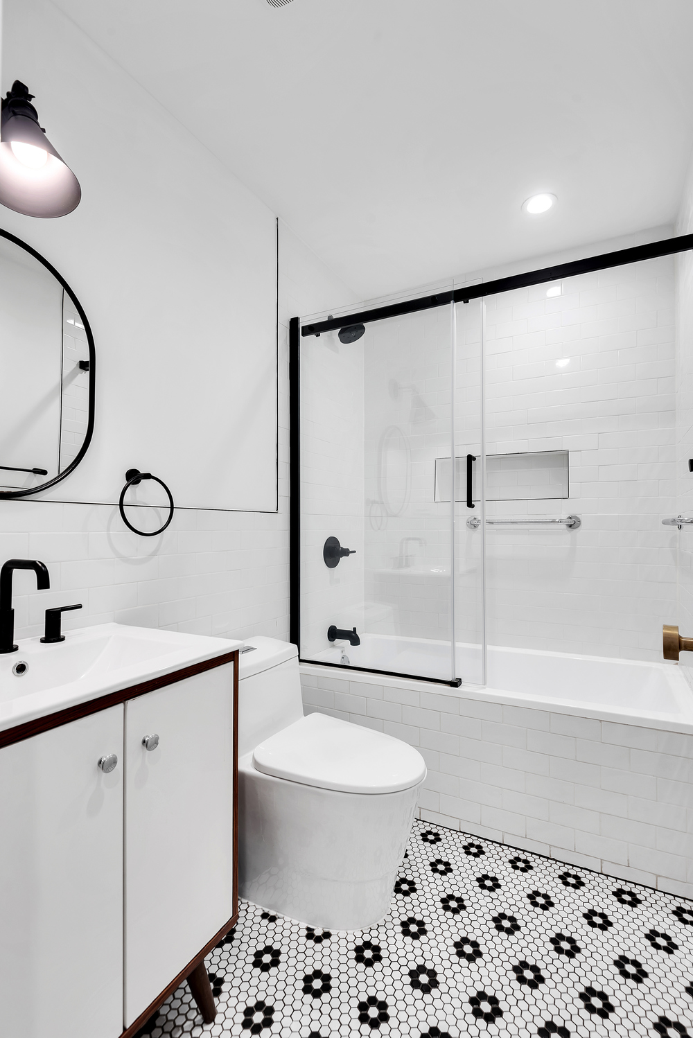 533 Decatur Street Brooklyn, NY 11233 - Photo 17 of 21 a bathroom with a sink a toilet and a shower