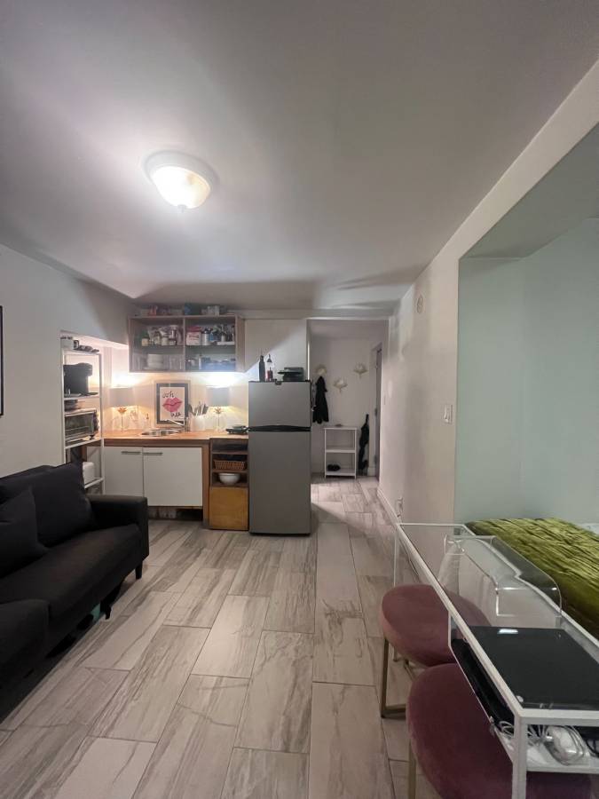 a living room with furniture and kitchen view