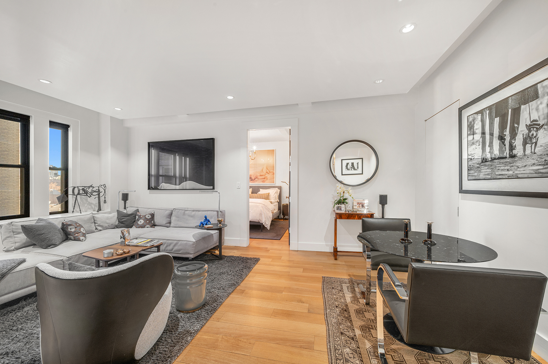 24 5th Avenue, Unit 824 Manhattan, NY 10011 - Photo 1 of 12 a living room with furniture and a mirror