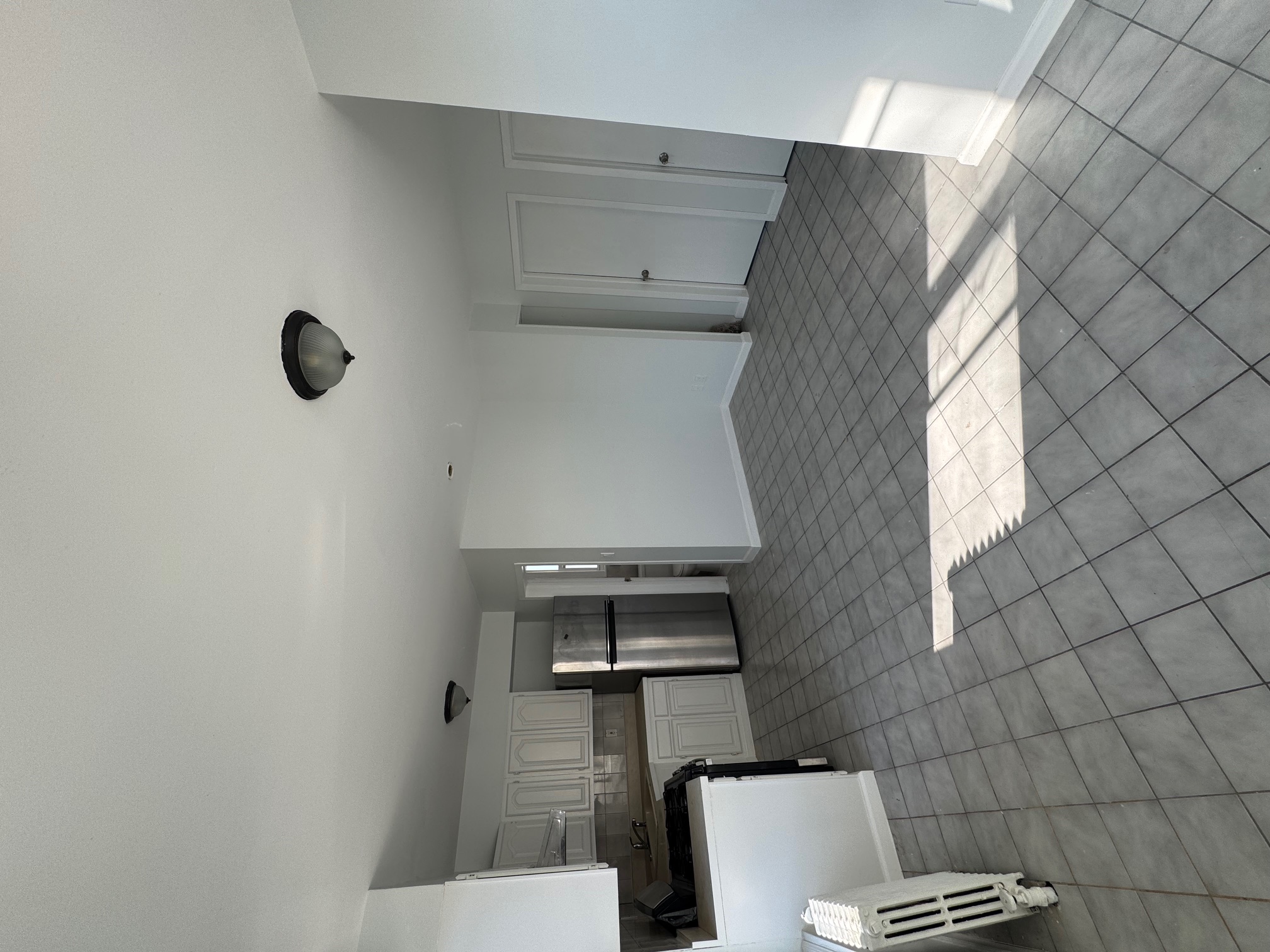 89-16 102nd Road, Unit 2 Queens, NY 11416 - Photo 6 of 13 a view of kitchen with furniture and window