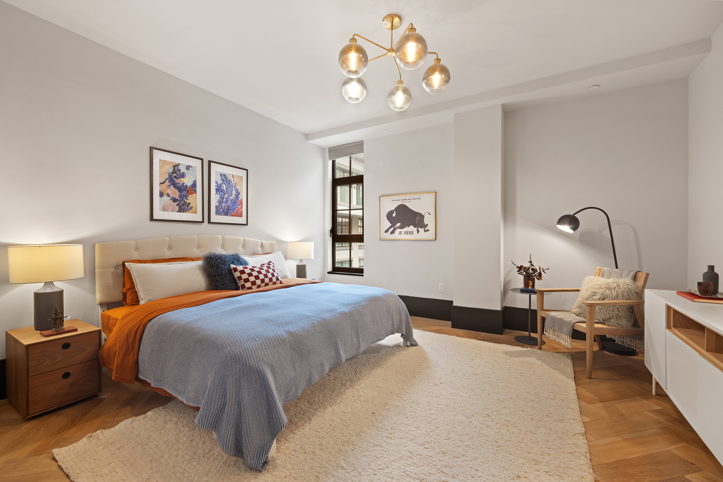 51 Jay Street, Unit 5J Brooklyn, NY 11201 - Photo 7 of 23 a bedroom with a bed and a chandelier