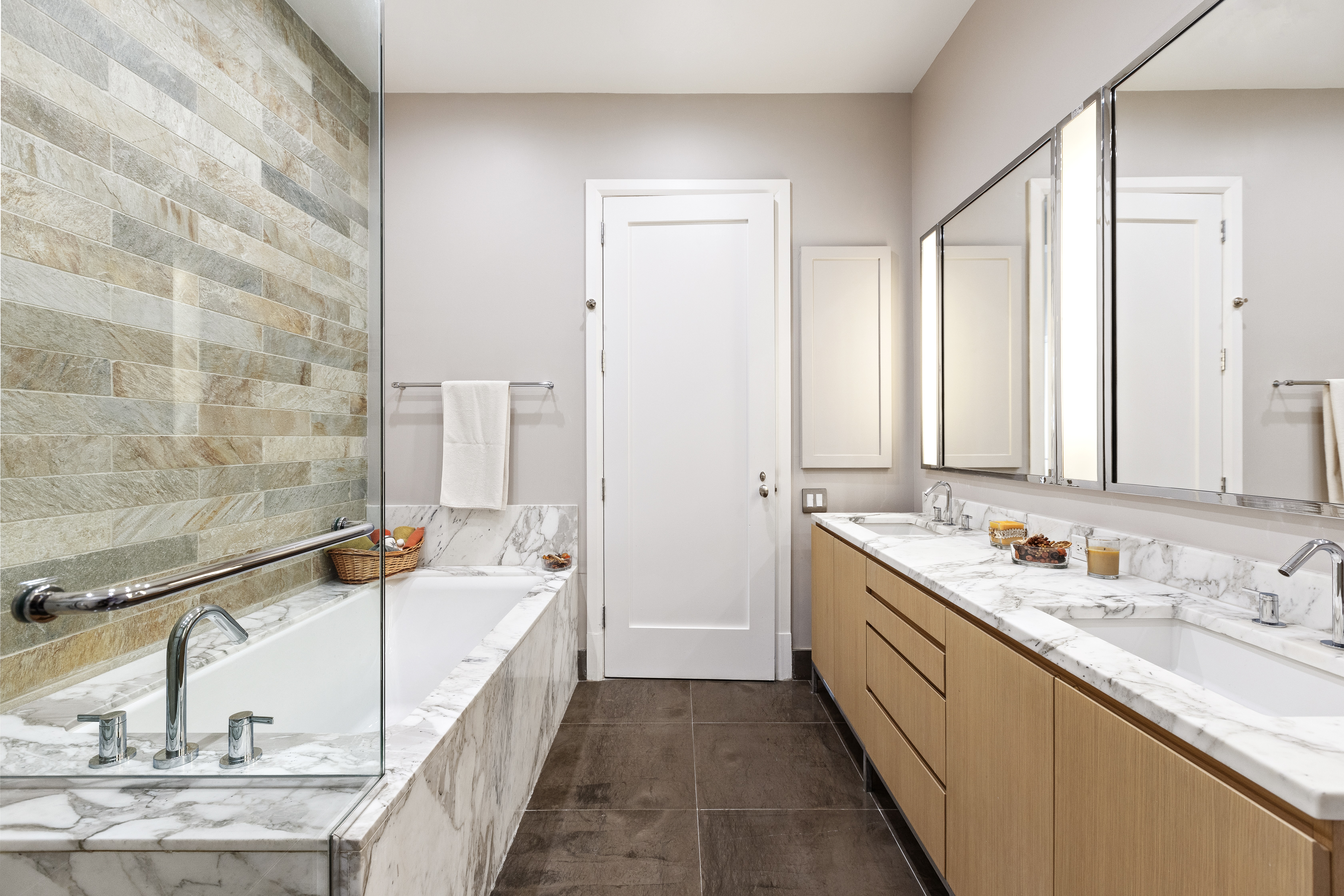263 9th Avenue, Unit 5B Manhattan, NY 10001 - Photo 6 of 14 a bathroom with a double vanity sink and mirror with bathtub