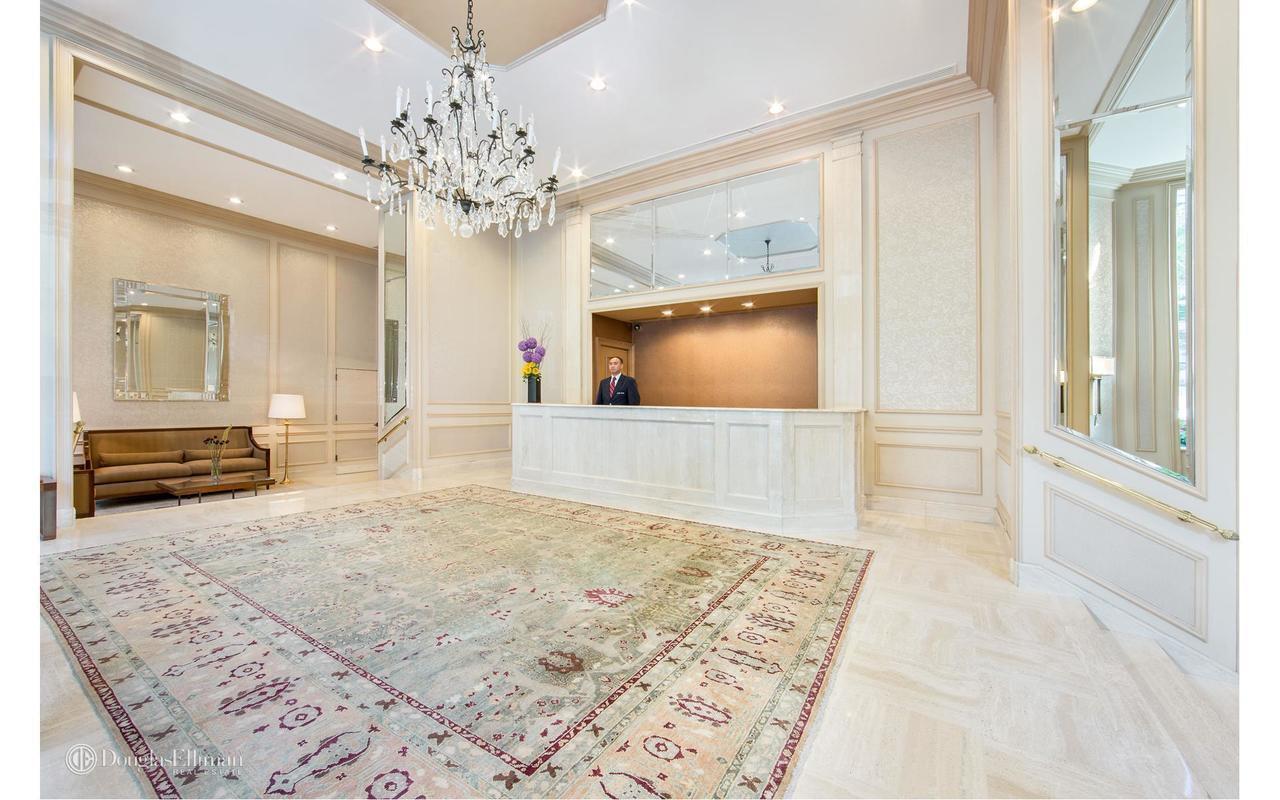 515 East 79th Street, Unit 15A Manhattan, NY 10075 - Photo 23 of 26 a view of a hallway with a chandelier and living room