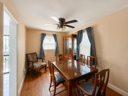 a dining room with furniture and window