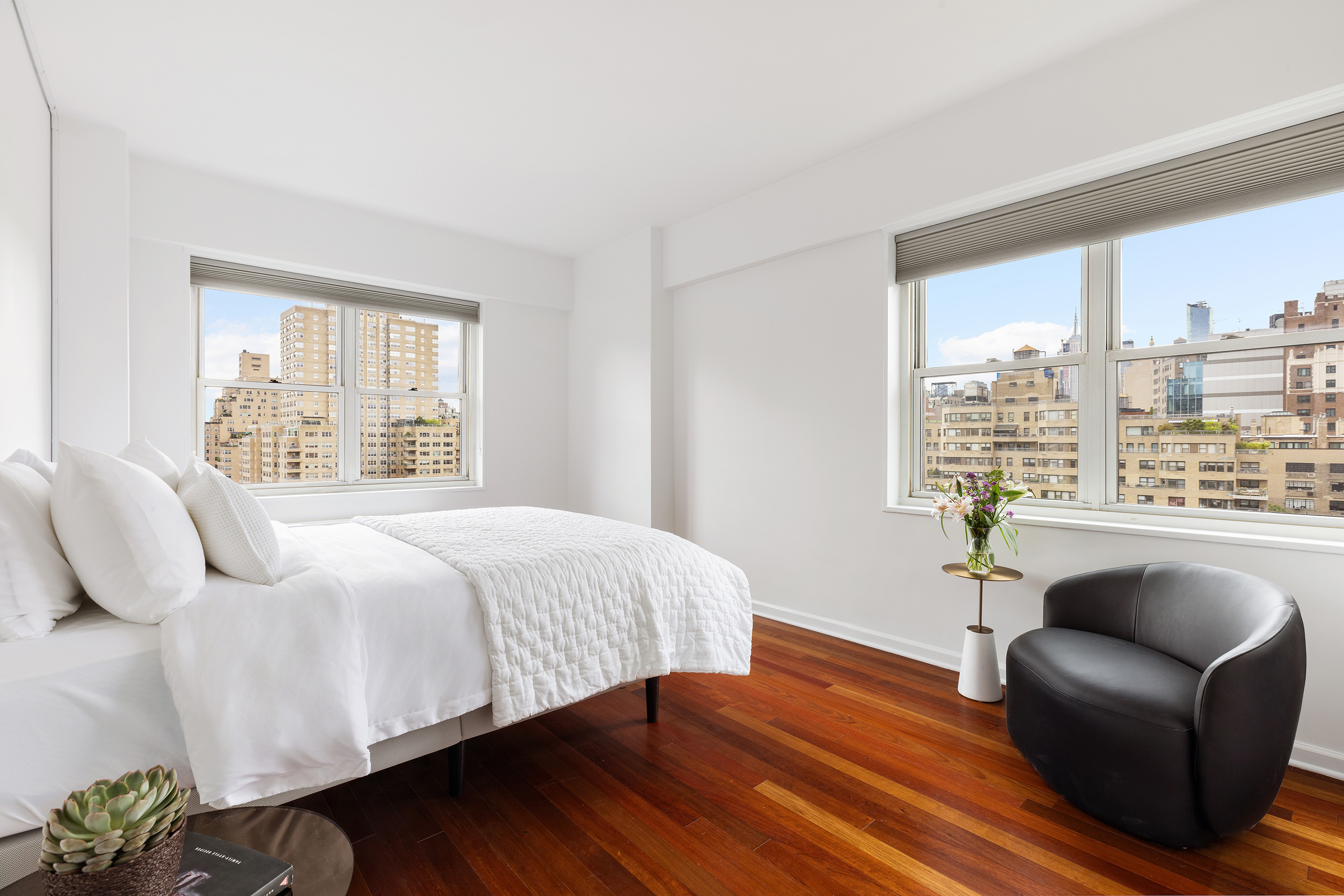 60 East 8th Street, Unit 10E Manhattan, NY 10003 - Photo 5 of 13 a bedroom with a bed couch and window