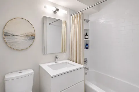 a bathroom with a sink a toilet and a mirror
