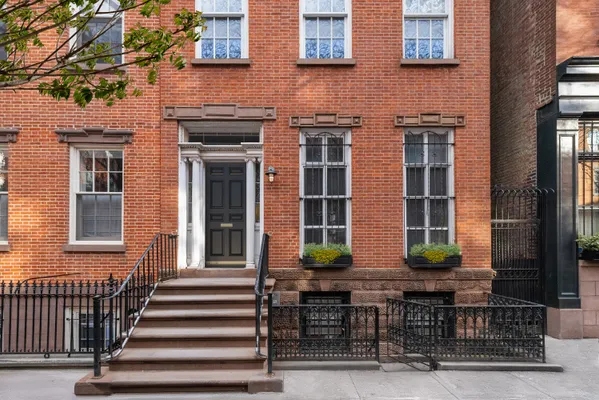 a front view of a brick building with large windows