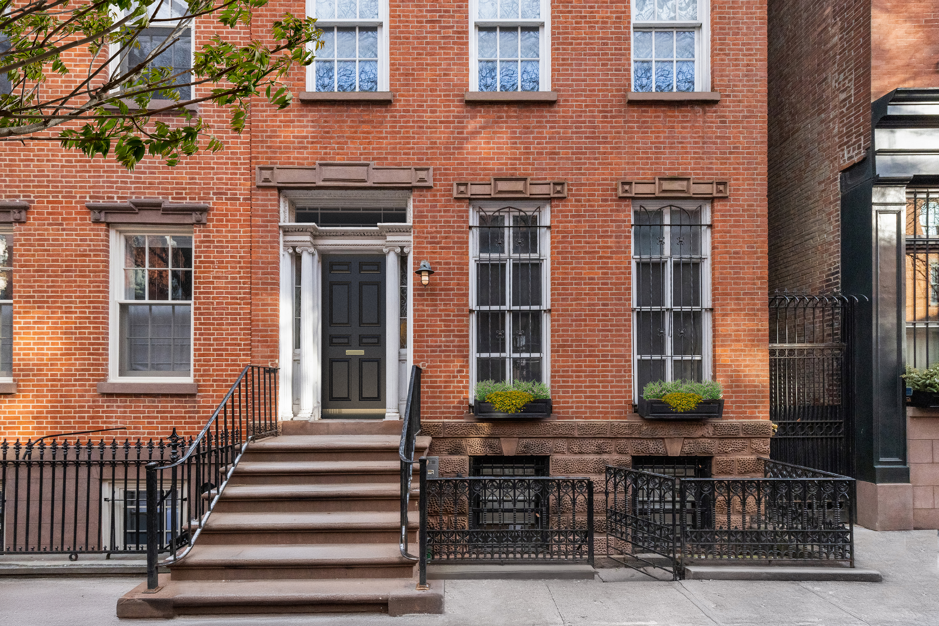 a front view of a brick building with large windows