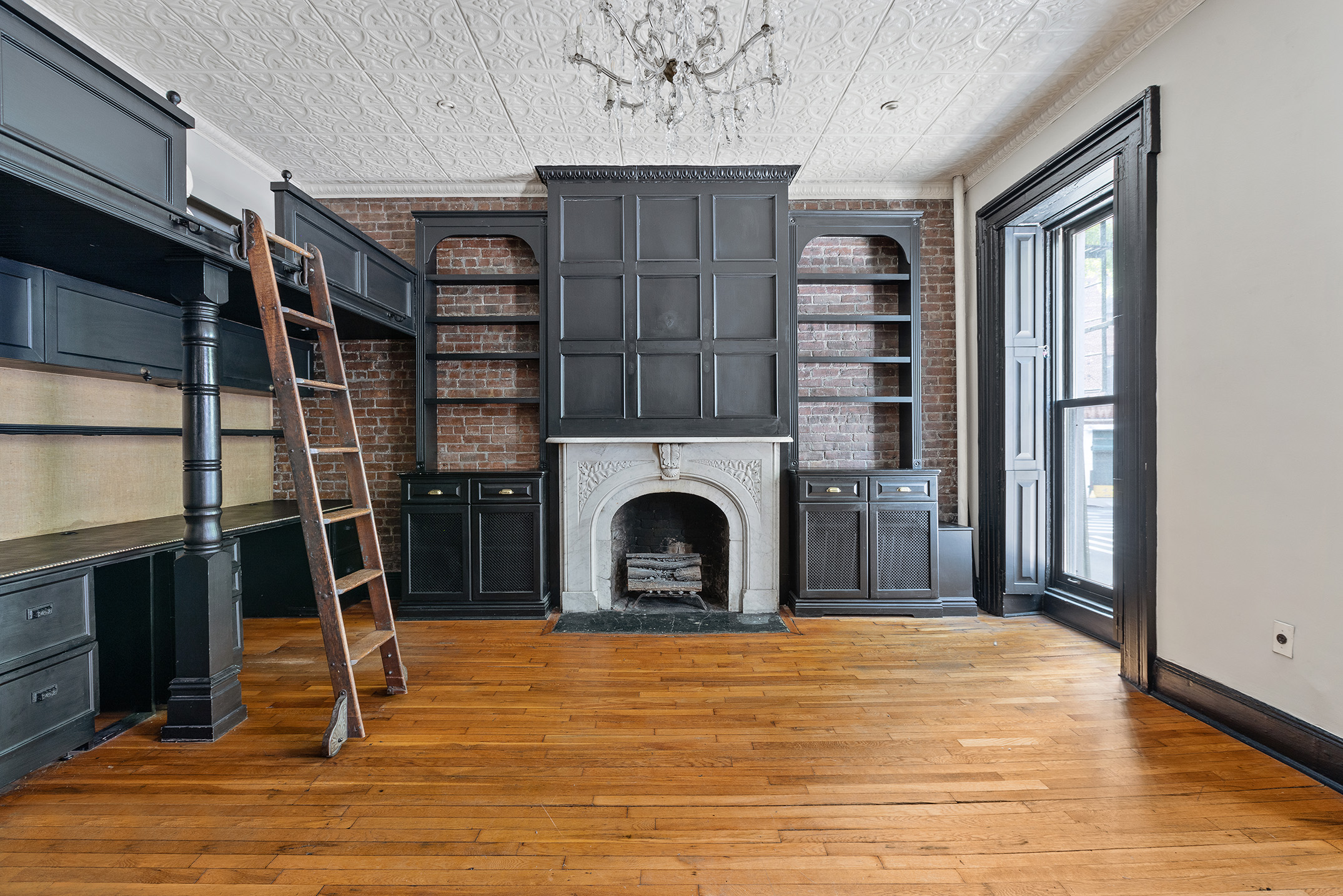 a view of a livingroom with fireplace and staircase