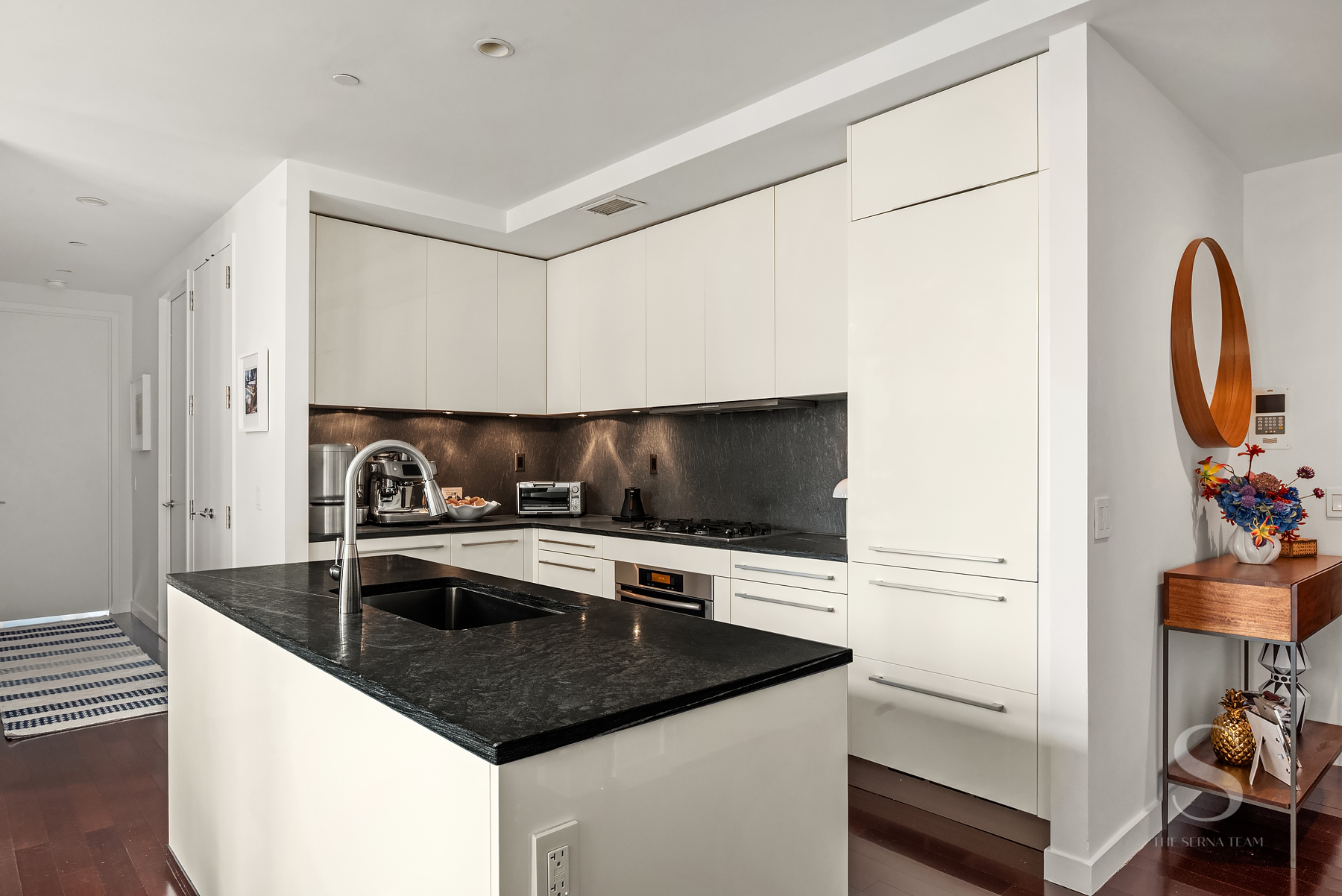 4 West 21st Street, Unit 14A Manhattan, NY 10010 - Photo 5 of 16 a kitchen with stainless steel appliances granite countertop a sink and a stove