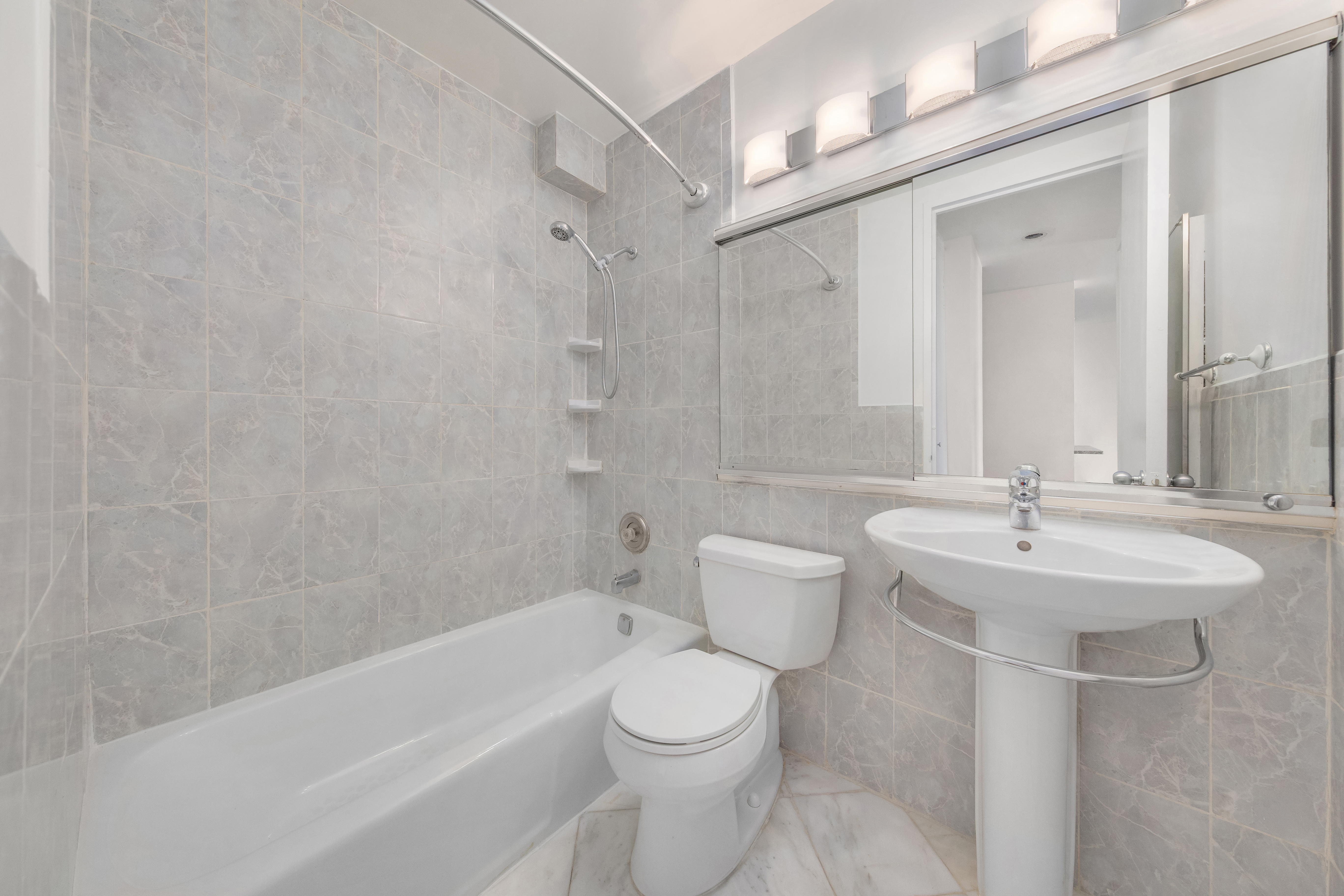 5 East 22nd Street, Unit 3N Manhattan, NY 10010 - Photo 4 of 9 a bathroom with a sink a toilet and a bathtub