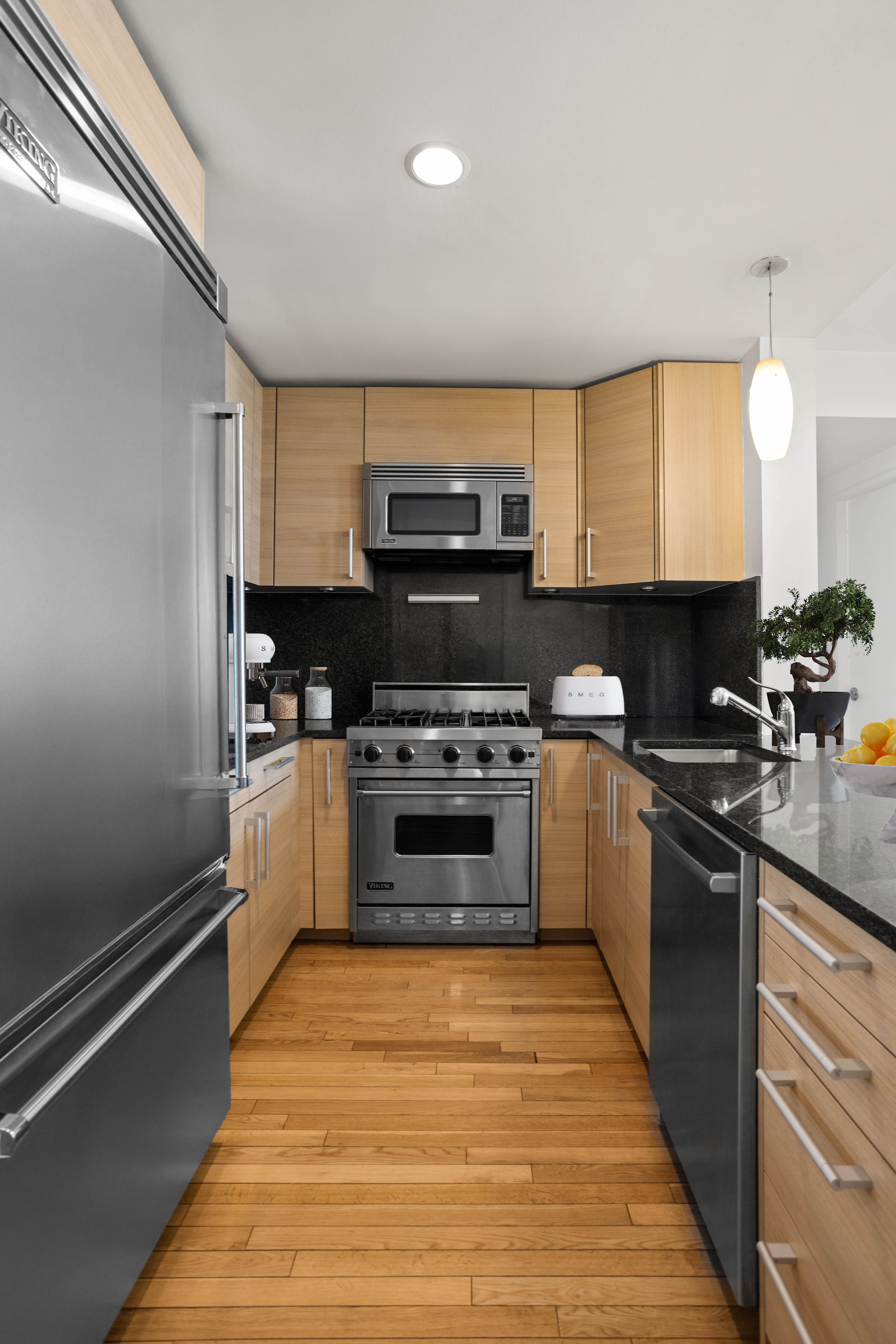 199 State Street, Unit 4C Brooklyn, NY 11201 - Photo 3 of 9 a kitchen with stainless steel appliances kitchen island granite countertop a stove a sink and a microwave