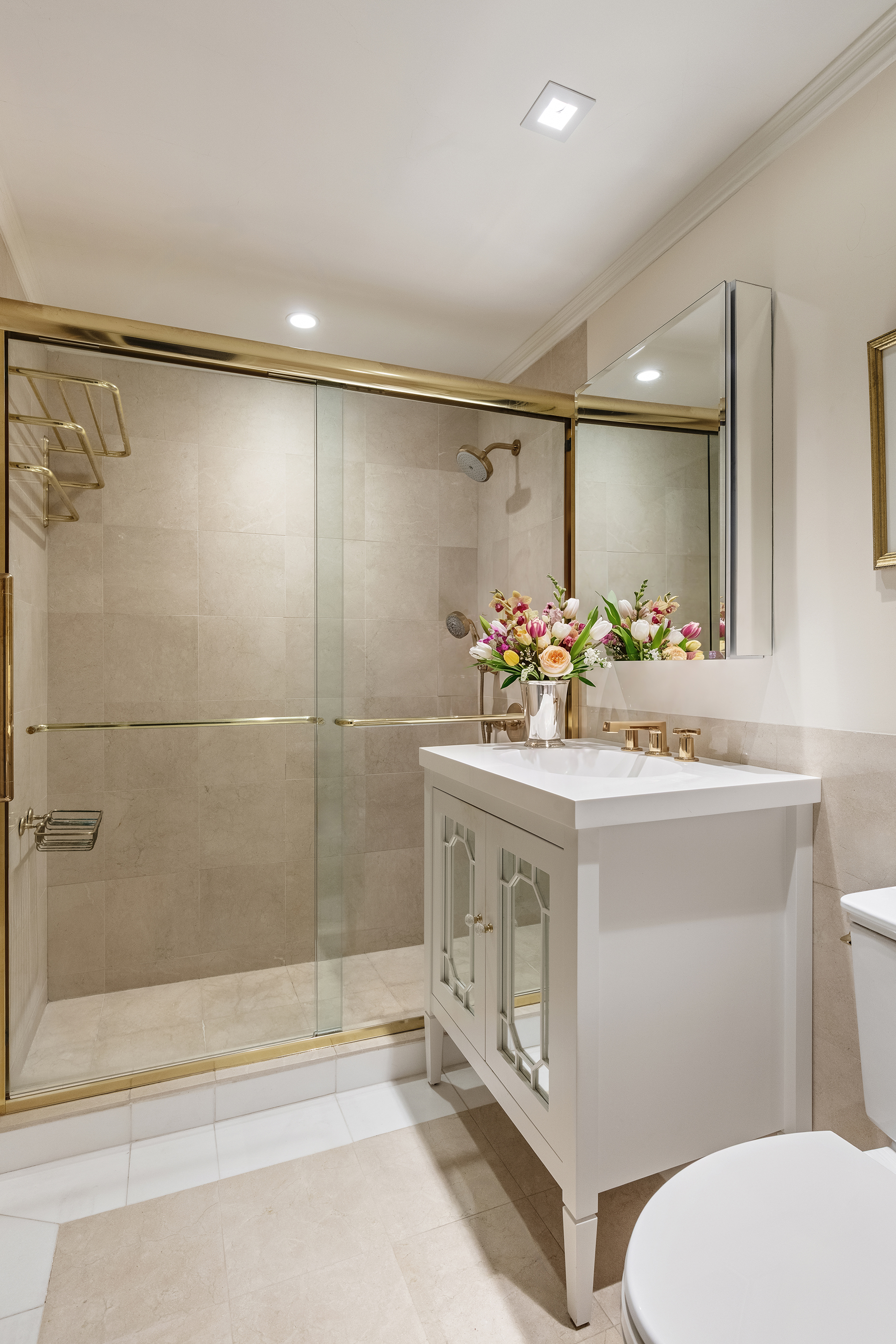 10 East 70th Street, Unit 3A Manhattan, NY 10021 - Photo 7 of 18 a bathroom with a sink mirror vanity and toilet