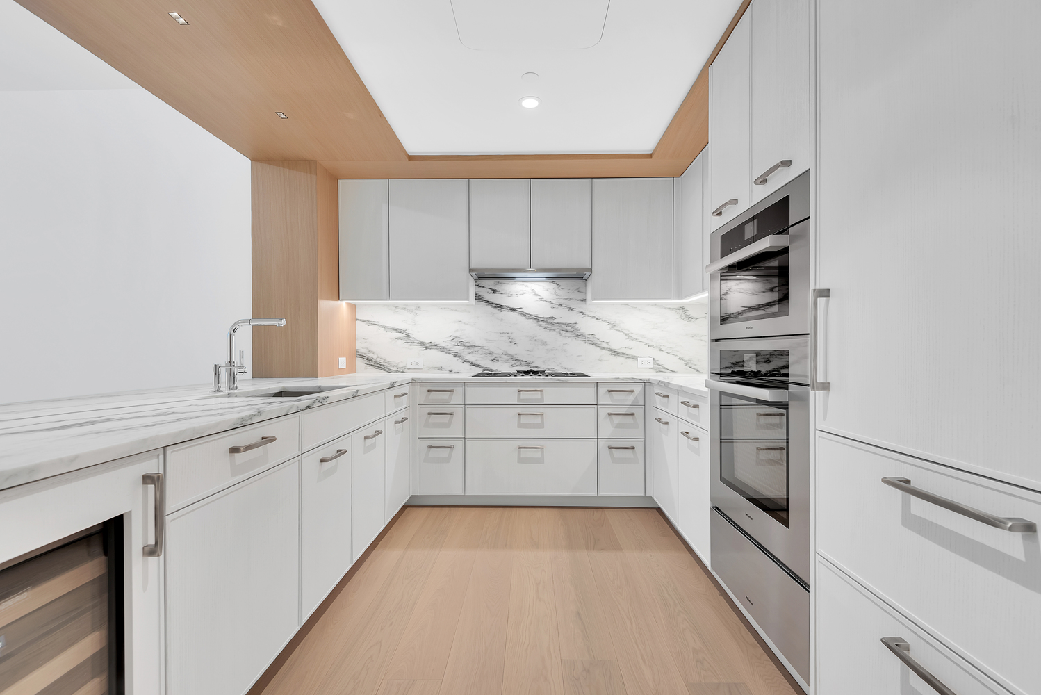 50 West 66th Street, Unit 7B Manhattan, NY 10023 - Photo 7 of 24 a kitchen with granite countertop cabinets stainless steel appliances and a sink