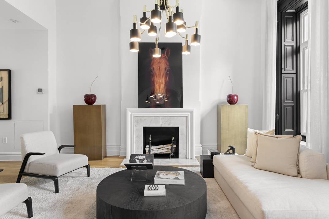 209 East 61st Street Manhattan, NY 10065 - Photo 4 of 24 a living room with furniture and a fireplace