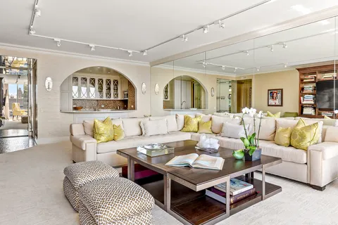 a living room with furniture a rug and a window