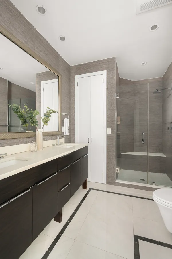 a bathroom with a tub sink mirror and shower