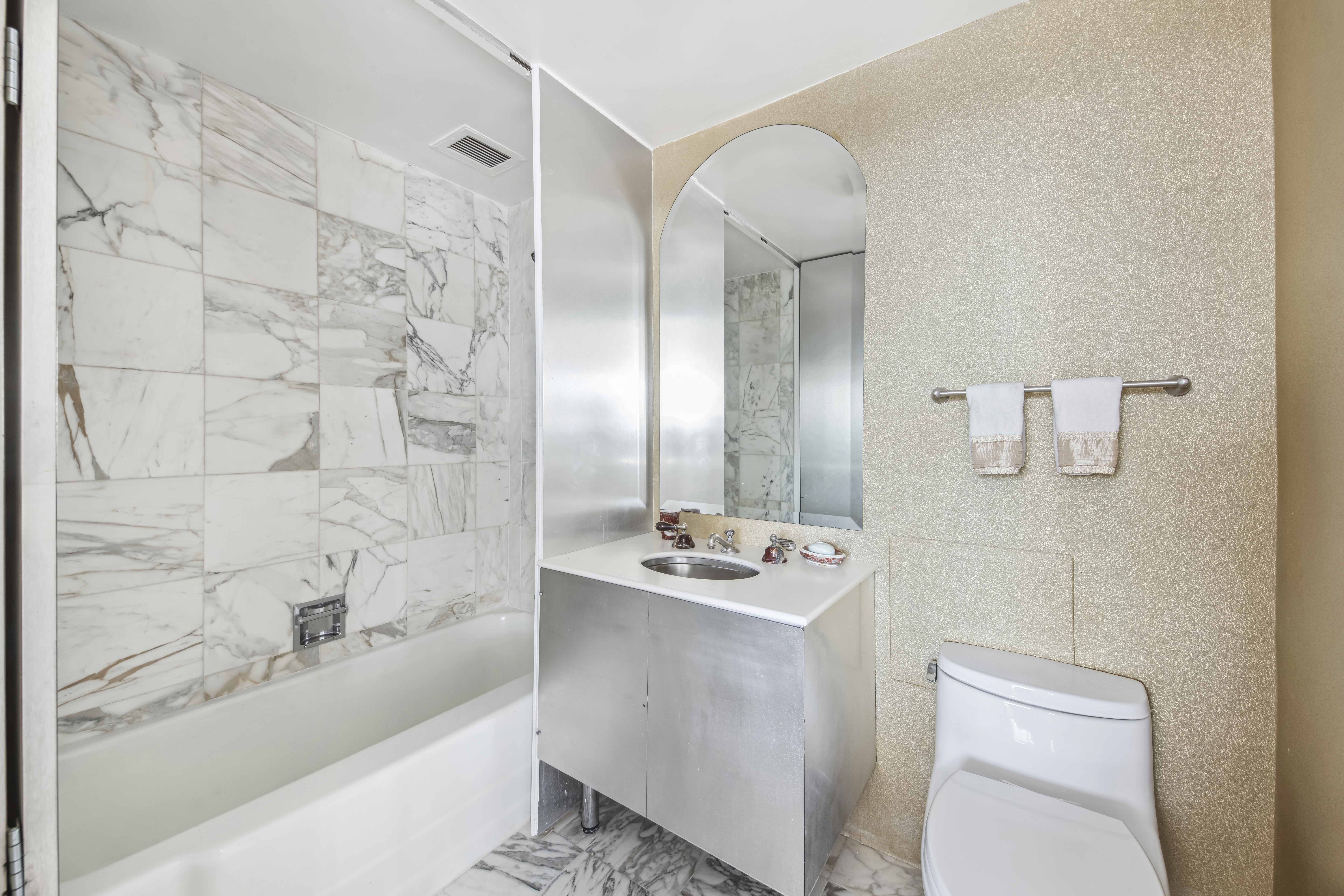 870 United Nations Plaza, Unit 15E Manhattan, NY 10017 - Photo 9 of 19 a bathroom with a sink a toilet and shower