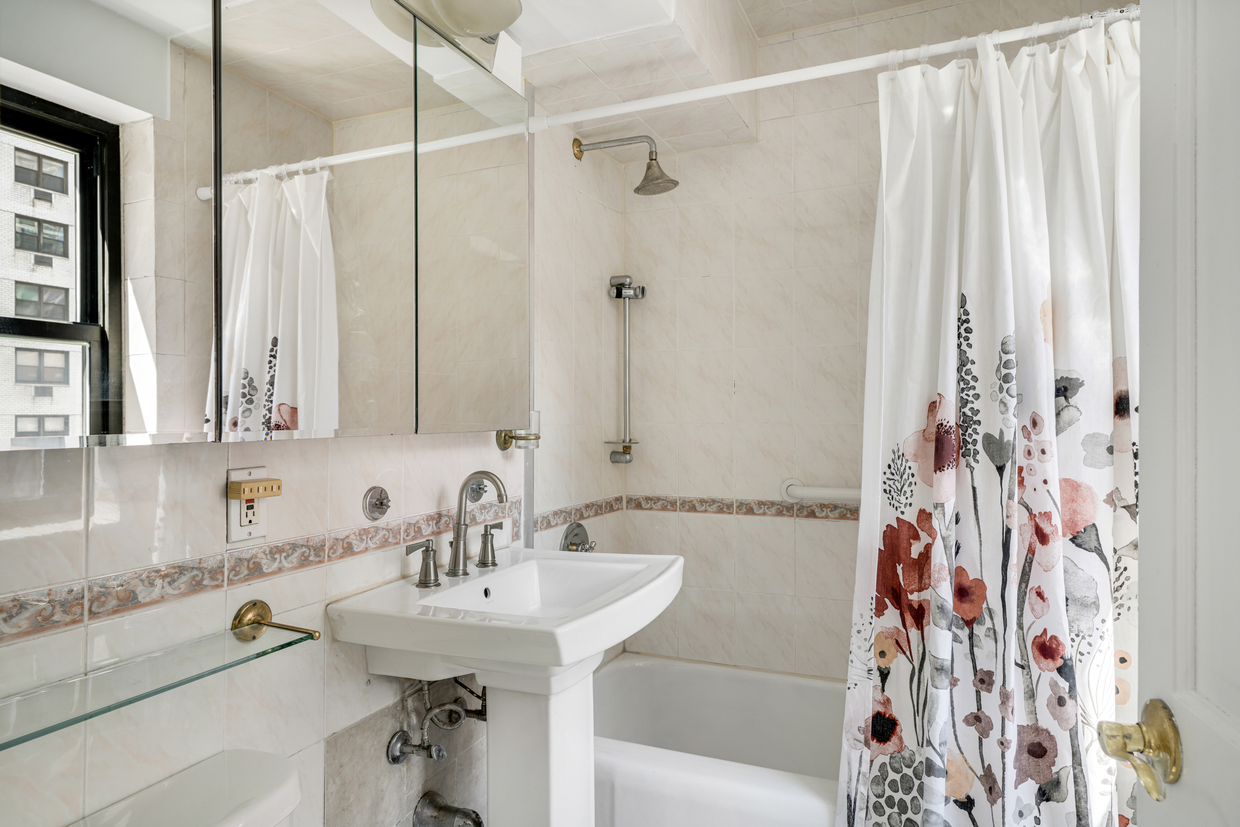 357 East 57th Street, Unit 5D Manhattan, NY 10022 - Photo 11 of 23 a bathroom with a sink and a mirror