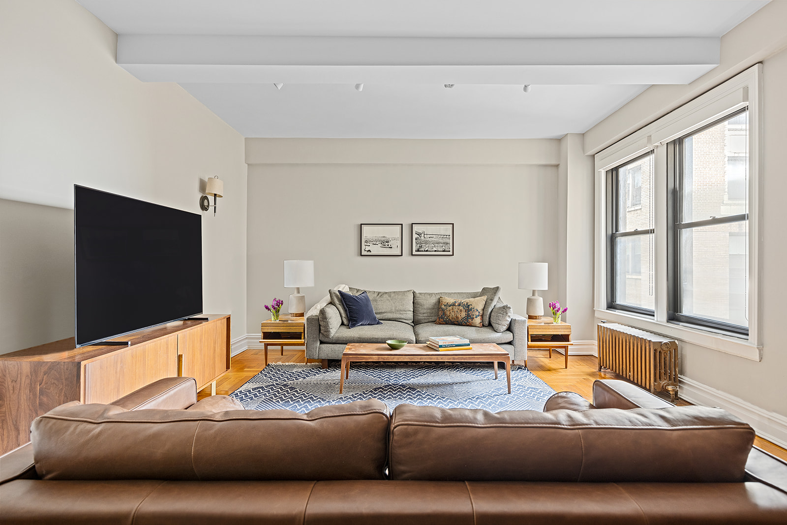 135 Eastern Parkway, Unit 13E Brooklyn, NY 11238 - Photo 4 of 15 a living room with furniture and a flat screen tv