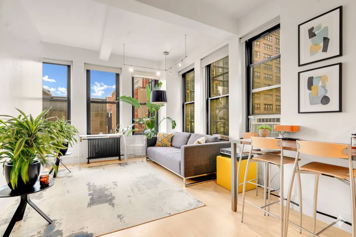 a living room with furniture large window and potted plants