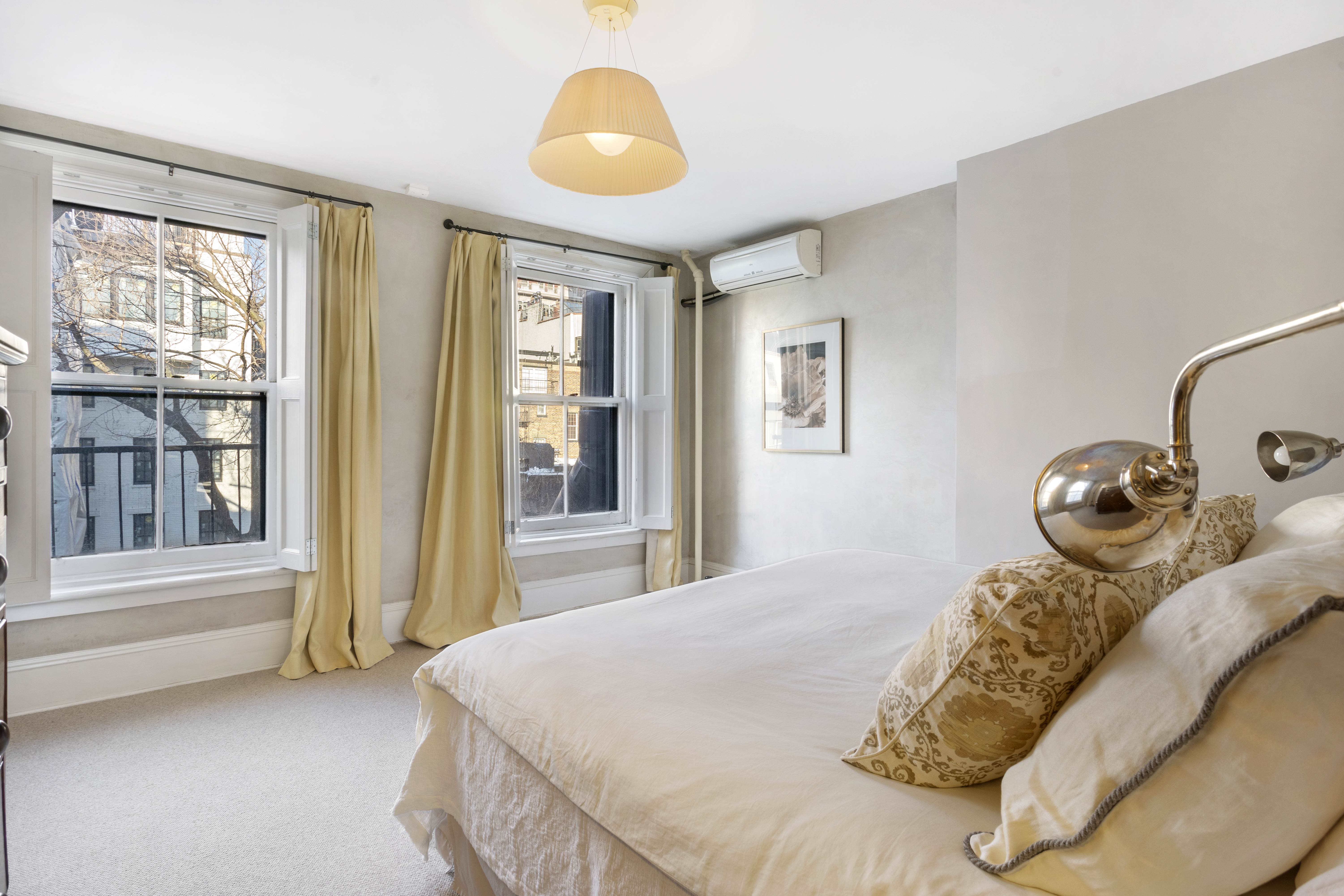 75 Washington Place, Unit TRIPLEX Manhattan, NY 10011 - Photo 7 of 14 a bedroom with a bed and window