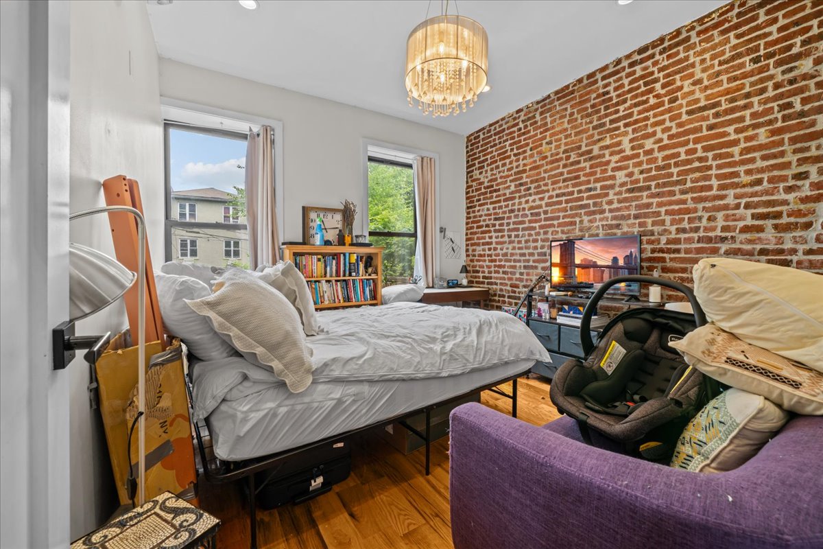 1509 Dean Street, Unit MULTI Brooklyn, NY 11213 - Photo 9 of 12 a bedroom with furniture and a wooden floor