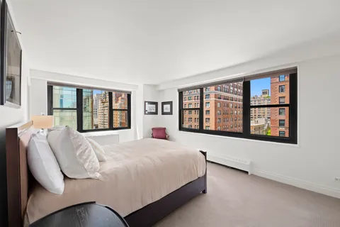 a bedroom with a large bed and a large window