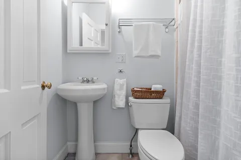 a bathroom with a sink toilet mirror and vanity