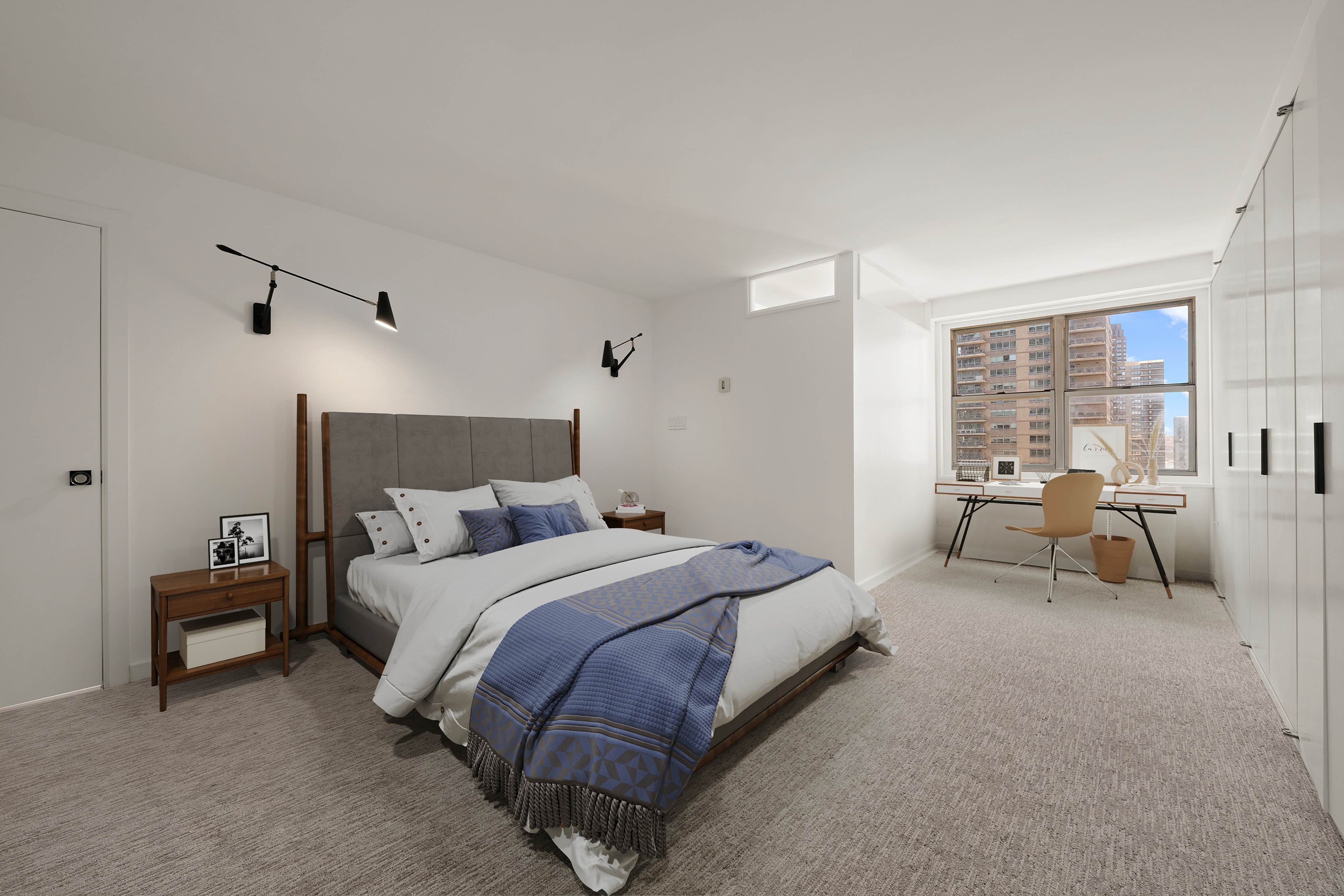 155 West 68th Street, Unit 1410 Manhattan, NY 10023 - Photo 9 of 11 a spacious bedroom with a bed and a couch