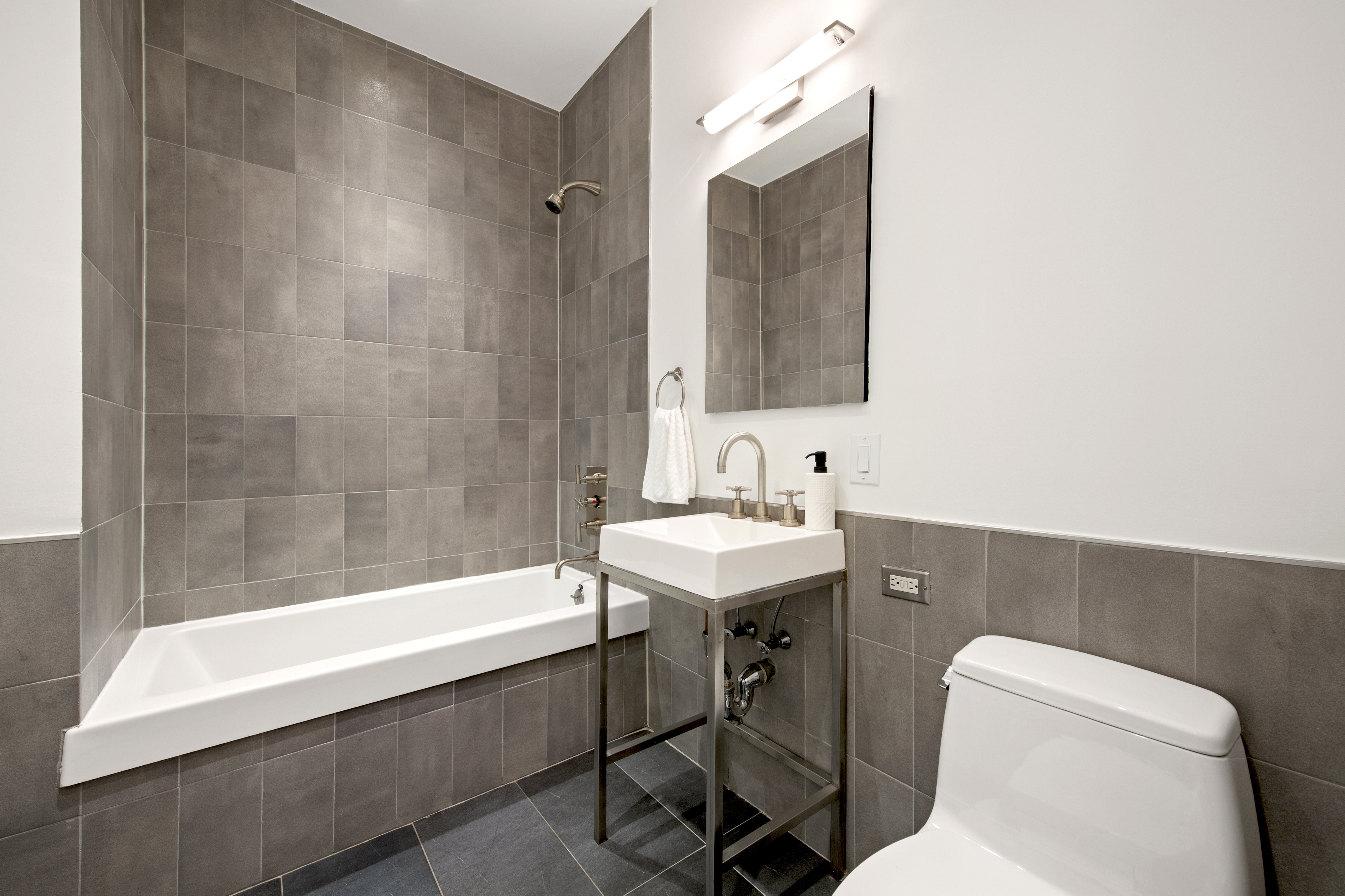 55 Berry Street, Unit 4B Brooklyn, NY 11249 - Photo 7 of 12 a bathroom with a sink a toilet and bathtub