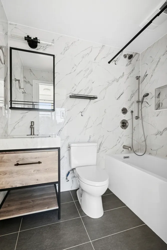 a bathroom with a sink toilet and shower