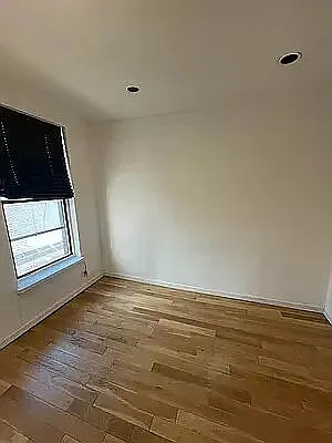 402 East 69th Street, Unit 23 Manhattan, NY 10065 - Photo 3 of 6 a view of an empty room and window