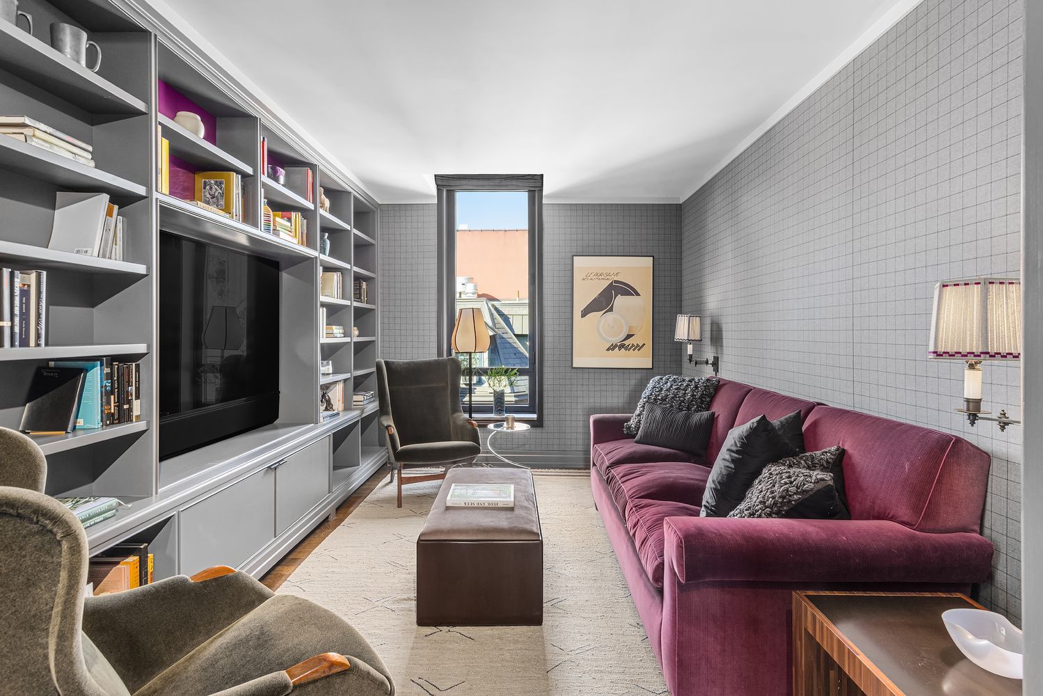 a living room with furniture a rug and a flat screen tv