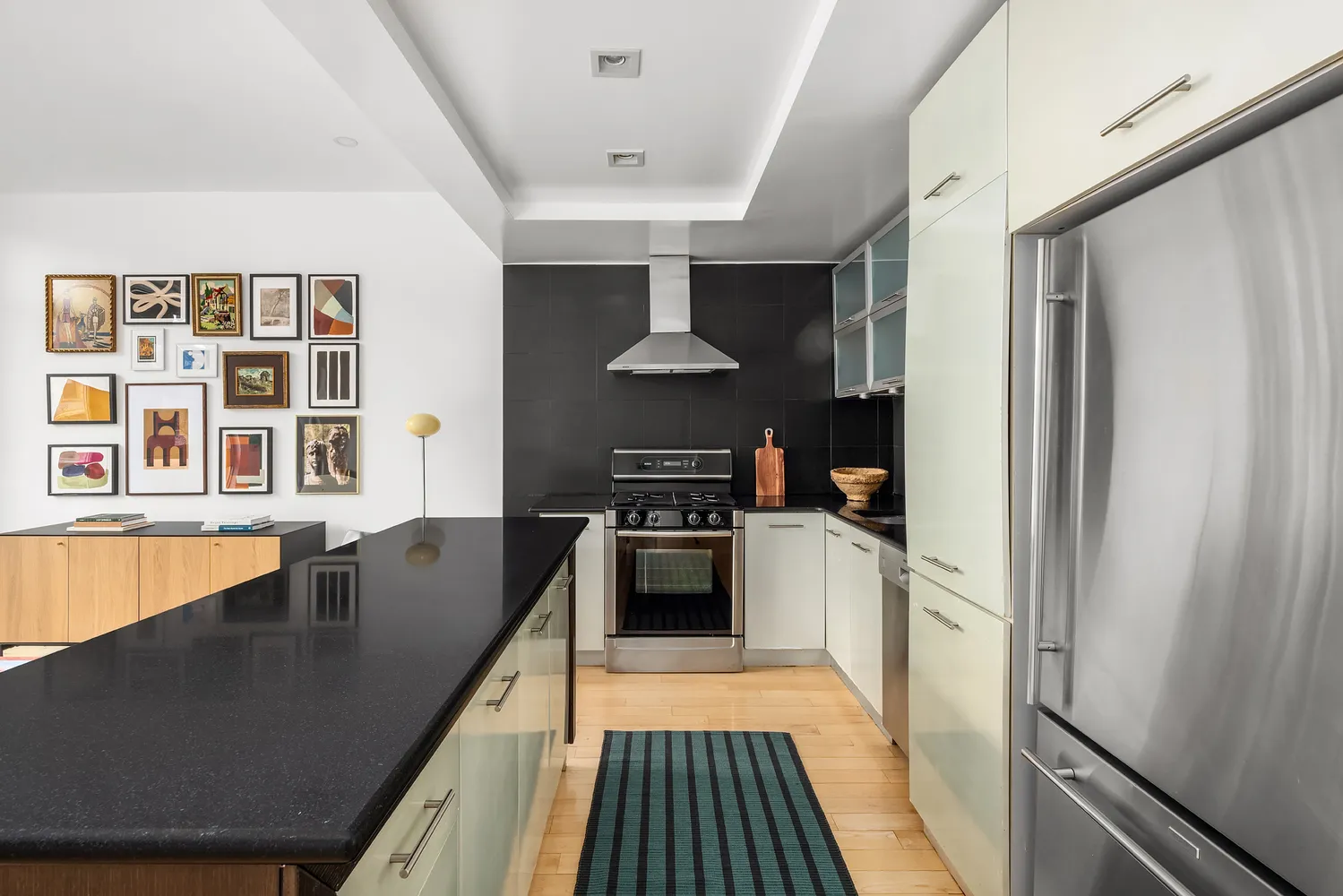 a kitchen with stainless steel appliances granite countertop a stove and a refrigerator