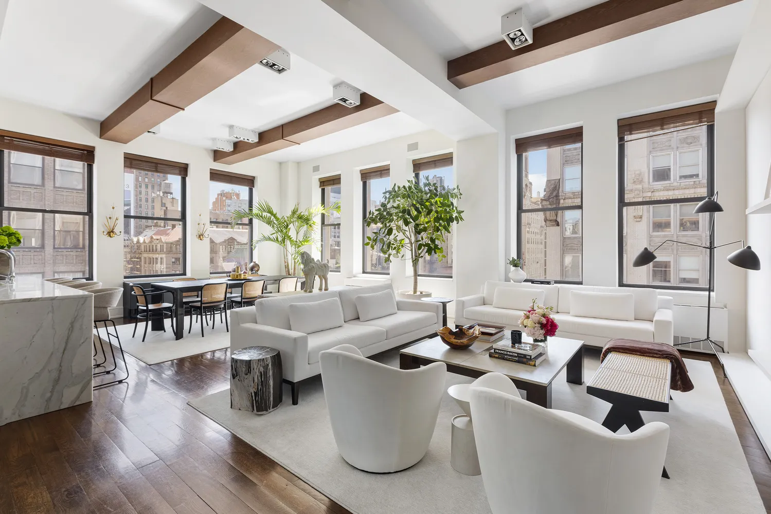 a living room with furniture and floor to ceiling windows