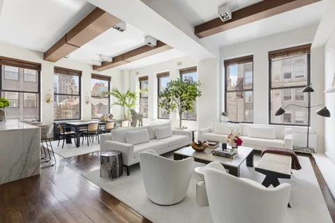 a living room with furniture and floor to ceiling windows