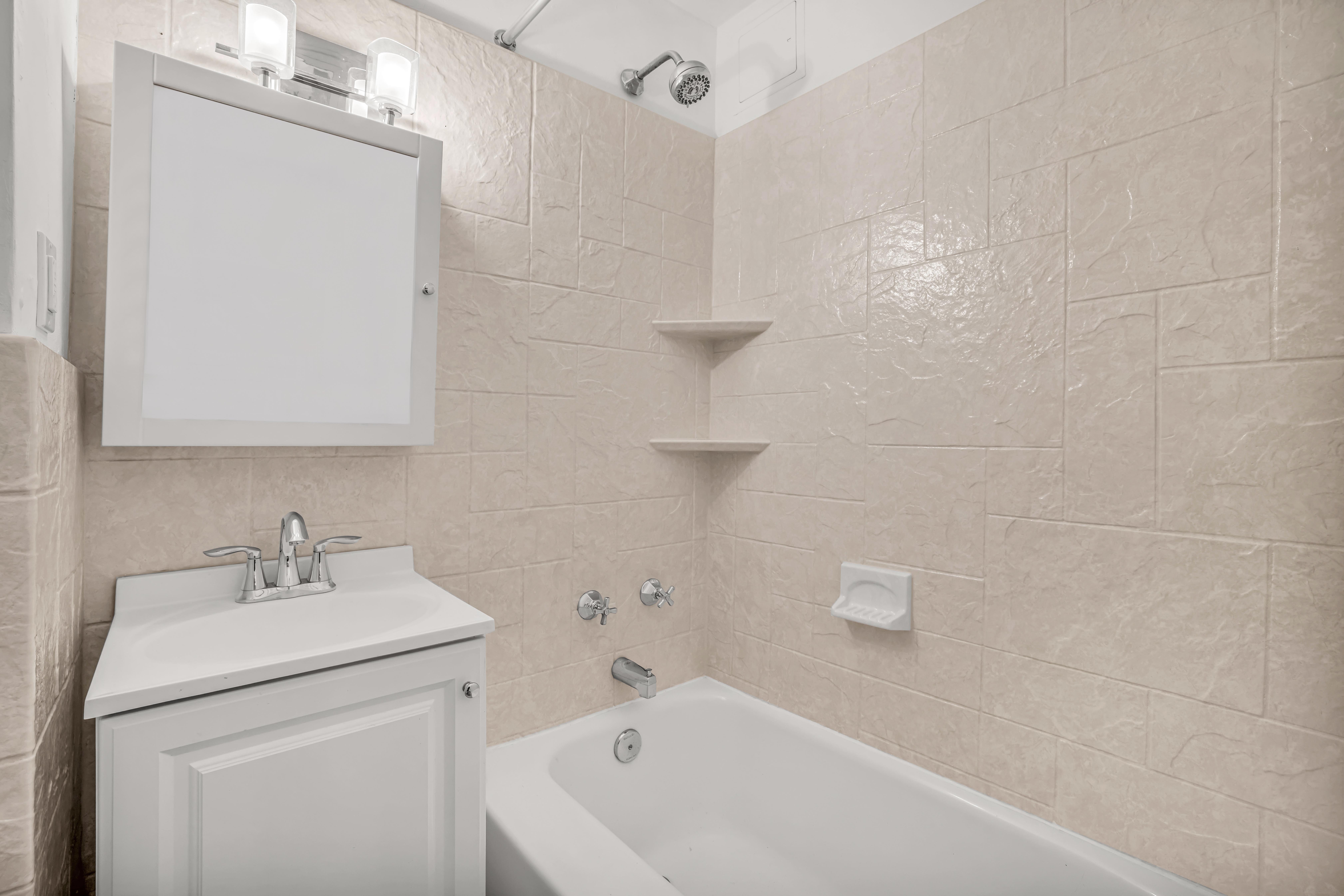 120 East 79th Street, Unit 7BC Manhattan, NY 10075 - Photo 10 of 12 a bathroom with a sink a toilet and shower