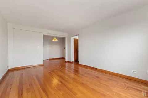 a view of an empty room and wooden floor