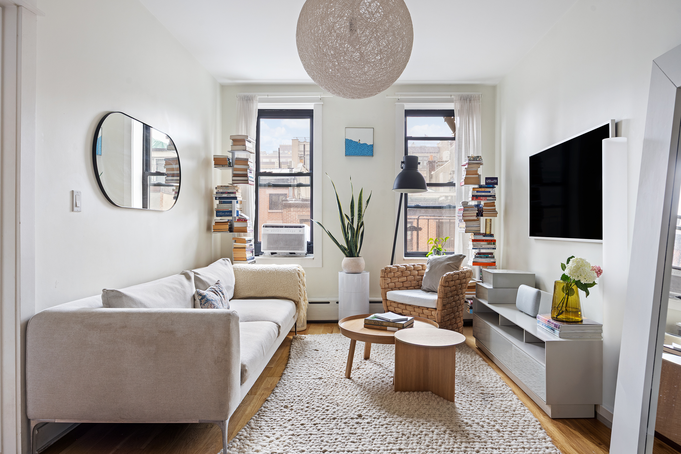 342 West 21st Street, Unit 4B Manhattan, NY 10011 - Photo 2 of 9 a living room with furniture and a flat screen tv